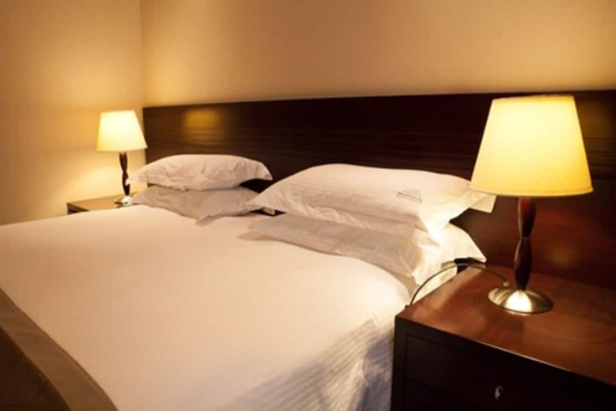 deluxe double room, pool view | premium bedding, minibar, in-room safe, desk