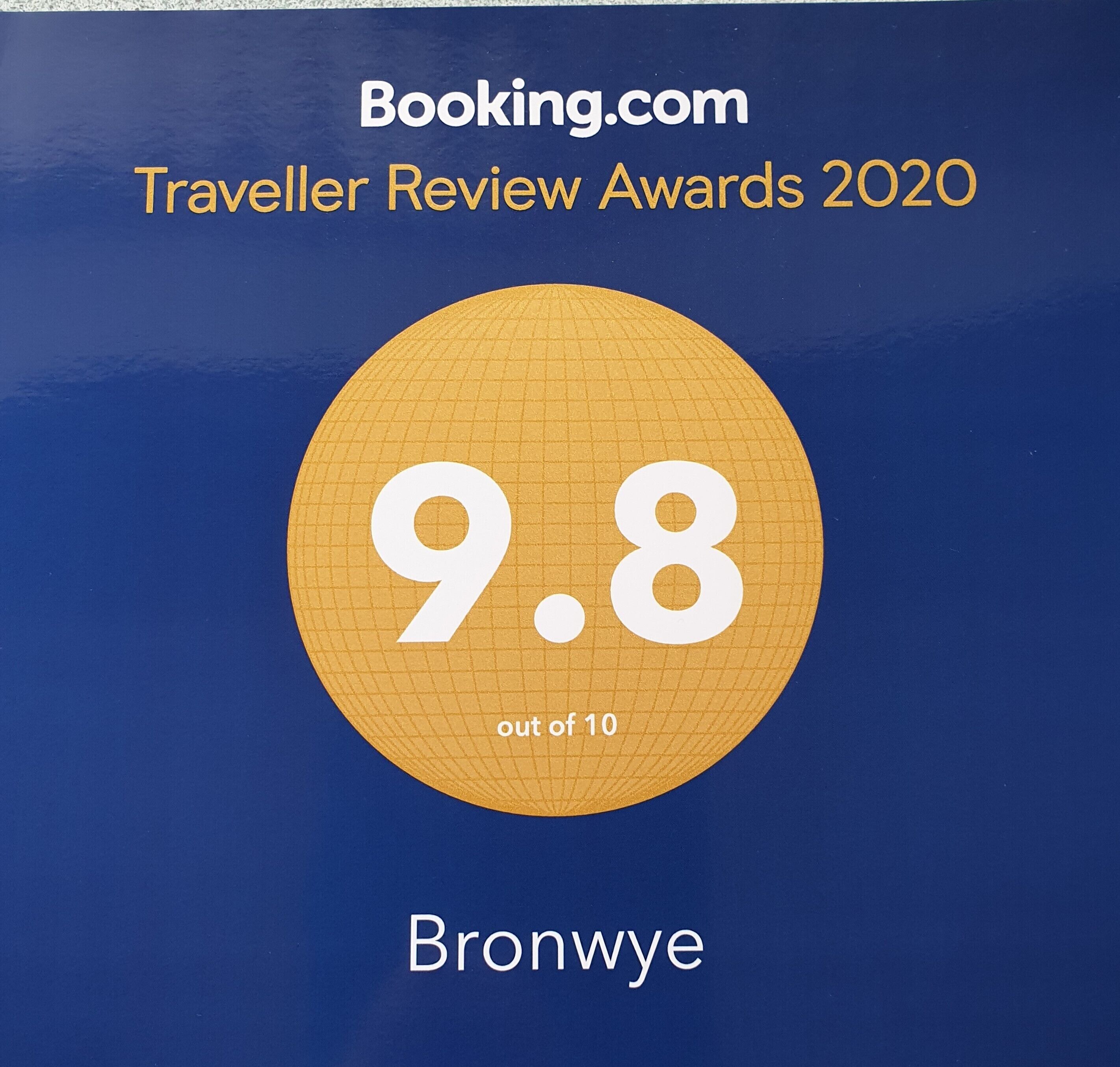 A blue background with a large gold circle in the center displaying the number 9.8 out of 10, and the word "Bronwye" at the bottom.