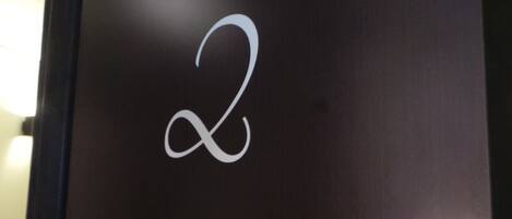 A dark wall with a white infinity symbol.