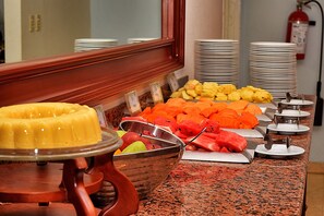 Indulge in a spread of fresh fruits and sweet treats at our buffet.