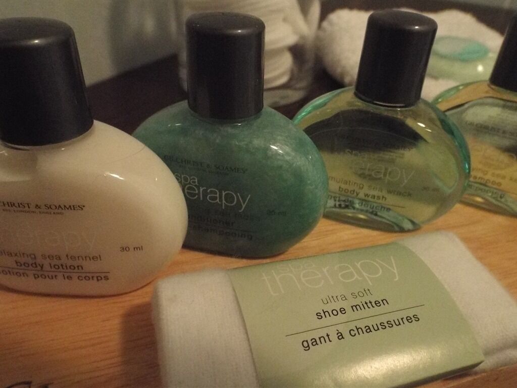 A collection of personal care products including a body lotion, a foot soak, and a shoe mist.