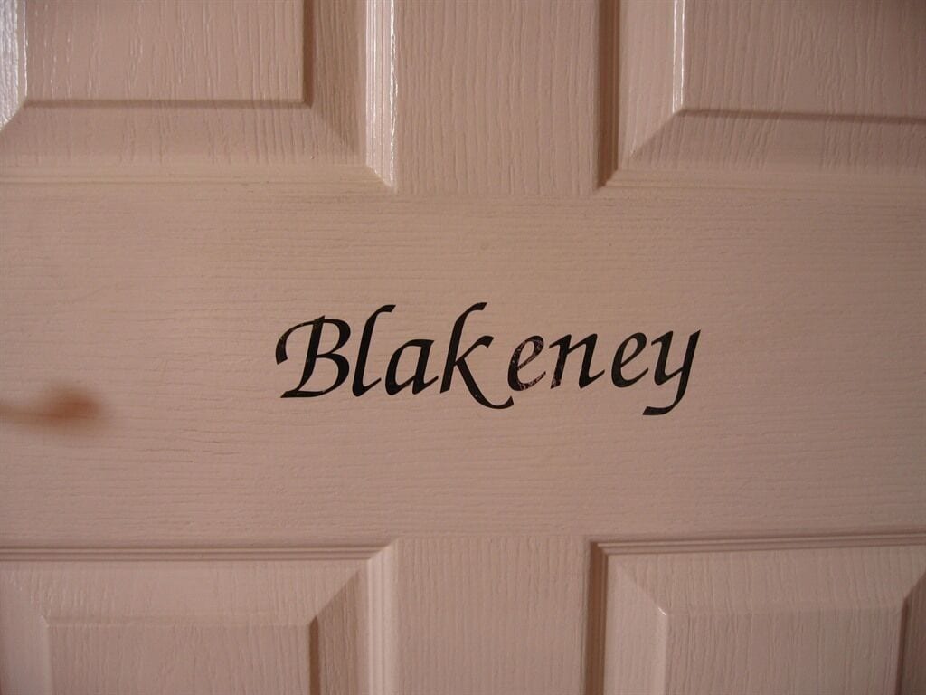A door with the name "Blakeney" carved into it.
