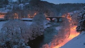 A snow-covered landscape with a bridge and buildings in the background. - The Buck INN (Richmond)