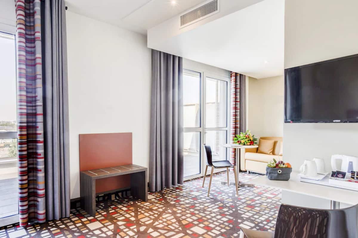 superior double or twin room, accessible, bathtub | living area | flat-screen tv