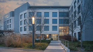 A modern building with a sign reading "Spark by Interio". - Spark by Hilton Lyon Eurexpo (Genas)