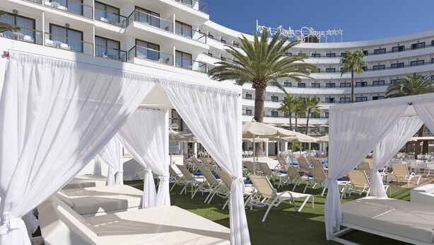A hotel with multiple white balconies, white canopies over beds, and a pool area with sun loungers. - Hotel HSM Linda Playa (Calvia)