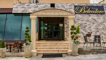 Step up to the Belvedere Hotel, where a beautiful stone archway greets you.