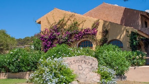 A building with a stone facade, arched windows, and a sign that reads "Residencia D."