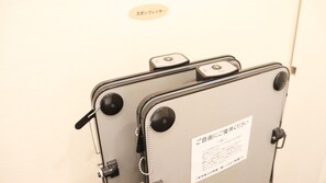 A suitcase with a label indicating it is for use by guests.