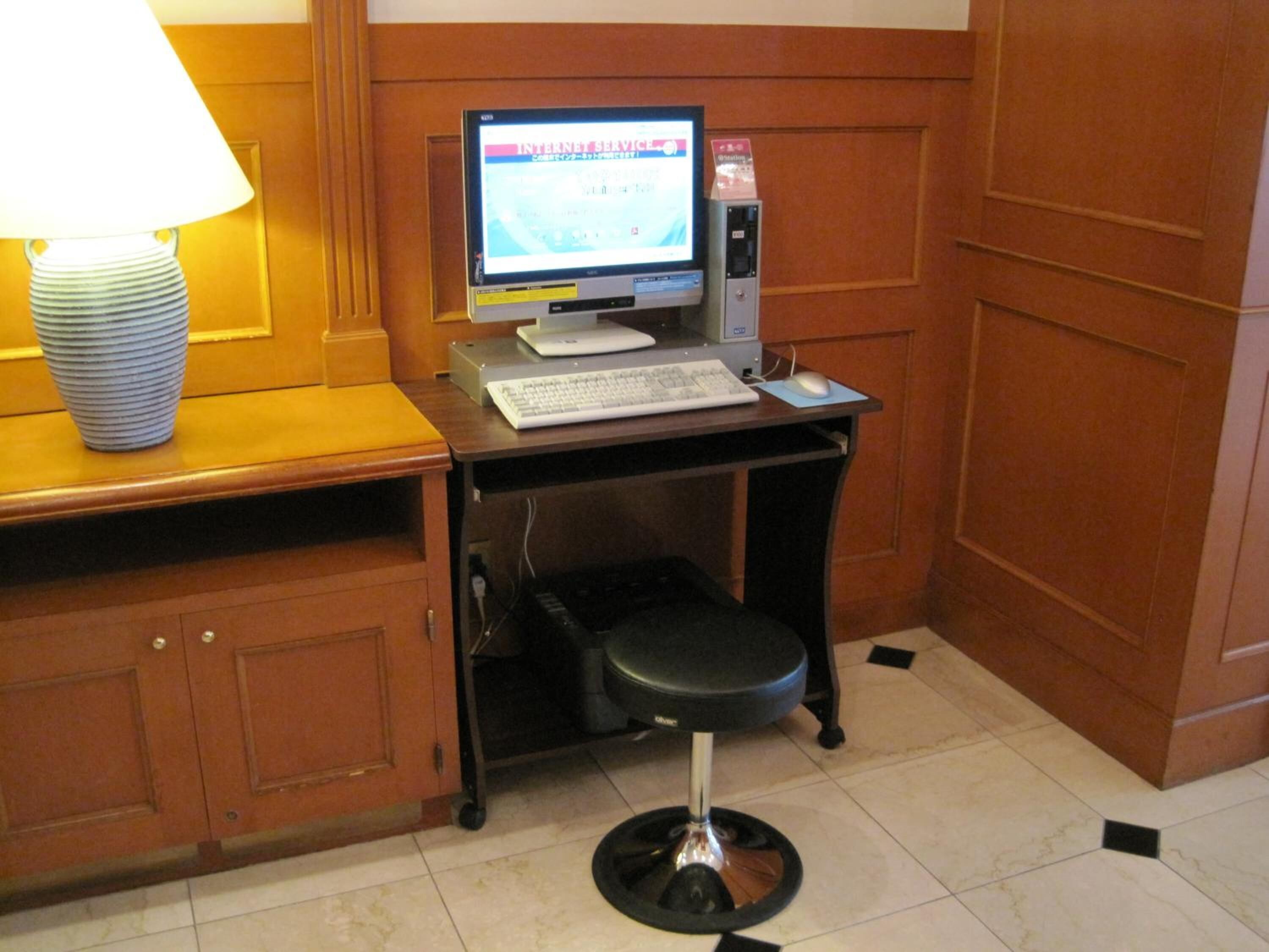 A small office space with a desk, computer, and a chair.
