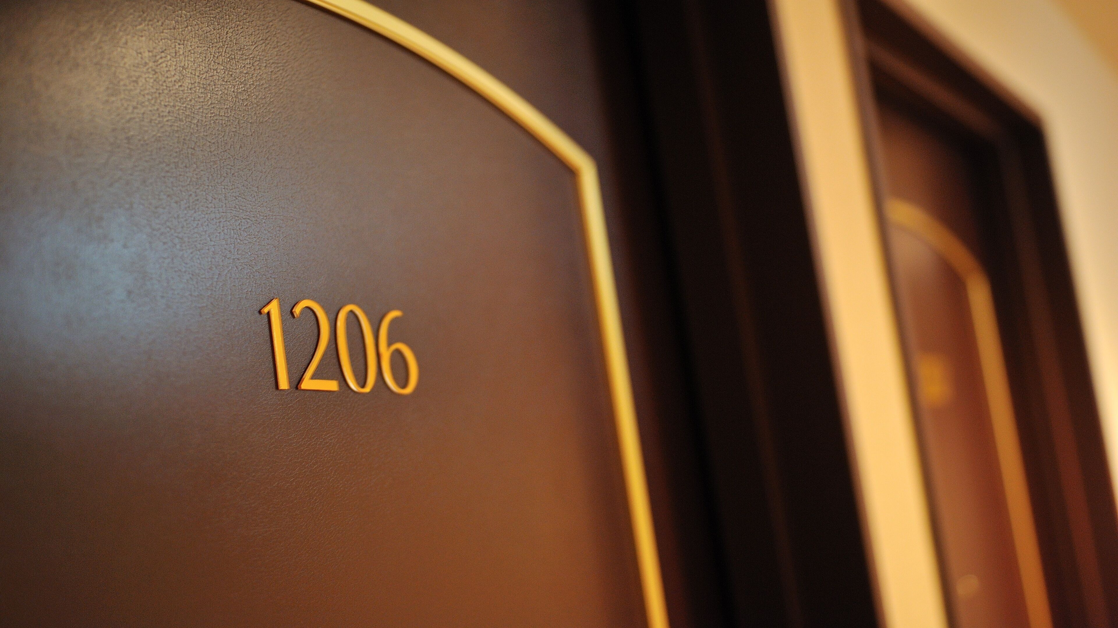 A close-up of a wall with the number 1206.