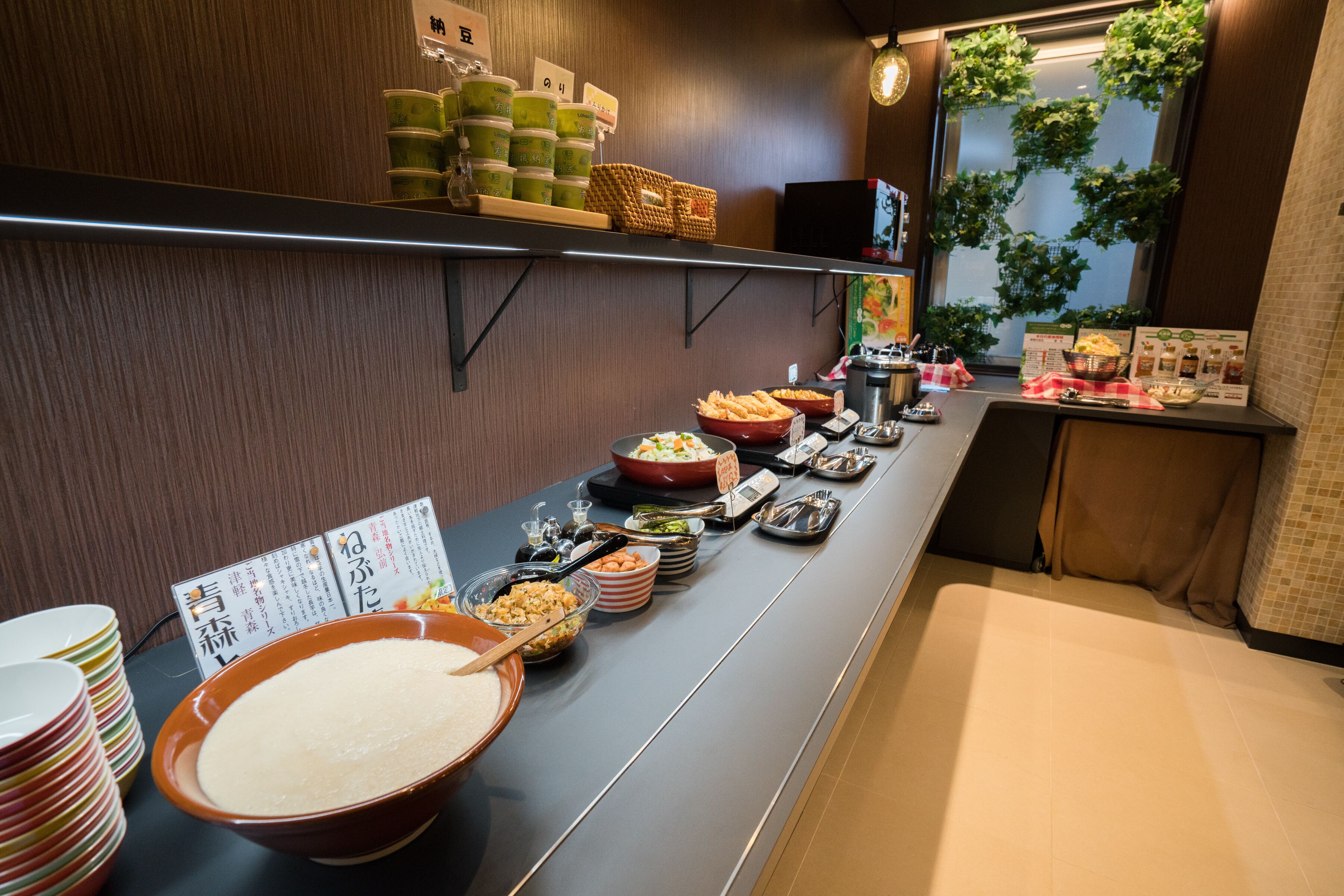 A buffet setup with various dishes and condiments.