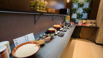 A buffet setup with various dishes and condiments.