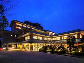 A modern hotel with a spacious lobby, multiple floors, and a well-lit entrance.
