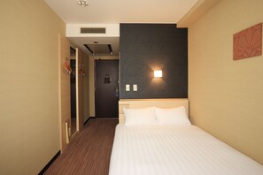 A hotel room with a bed, a nightstand, a wall-mounted light, a door, and a coat rack. - Smile Hotel Otsu Seta (Otsu)
