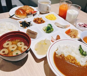 A table with various dishes including rice, soup, and vegetables.