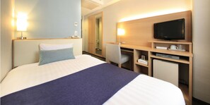 A hotel room with a bed, a desk with a television, and a chair. - Shonandai Dai-Ichi Hotel Fujisawa Yokohama (Fujisawa)