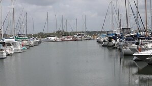 A marina with numerous boats docked in calm waters. - Tin Can Bay Budget Accommodation - Hostel (Tin Can Bay)