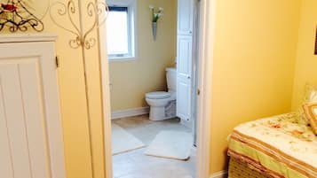 Bathroom features a toilet, sink, and window.