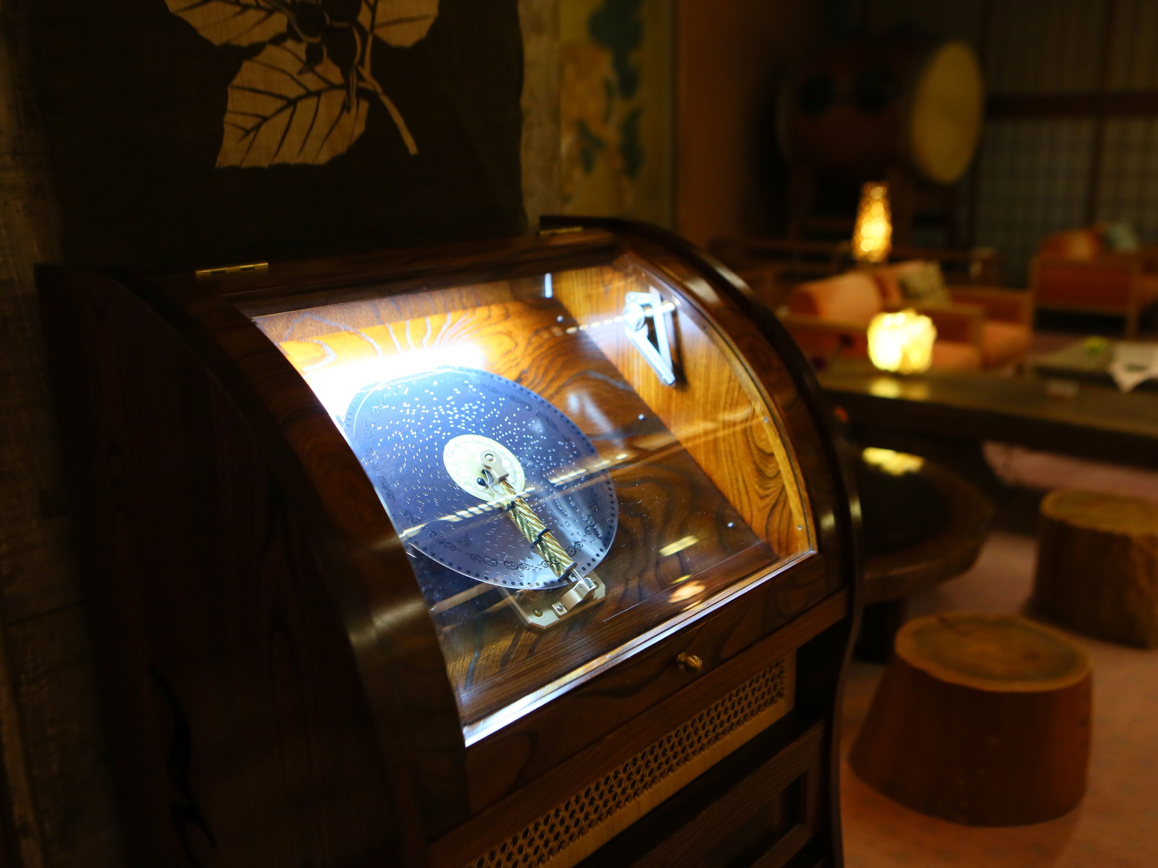 A jukebox with a glass front displaying a vinyl record.