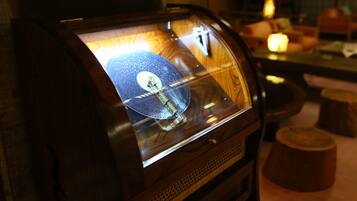 A jukebox with a glass front displaying a vinyl record.