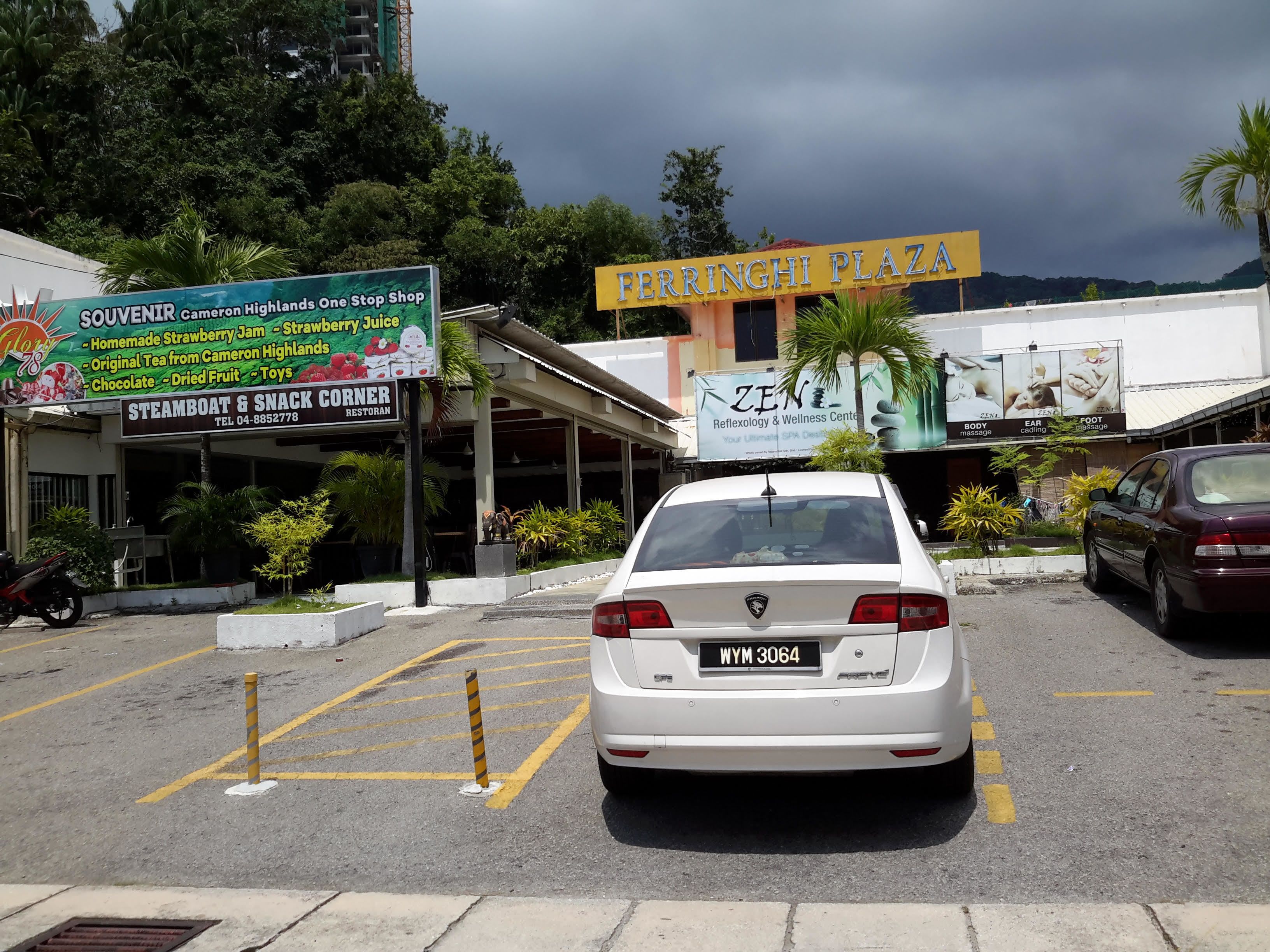 A parking lot with a white car, a sign for 'FERRINGHI PLAZA', and a 'STEAMBOAT & SNACK CORNER RESTORAN' with a telephone number.