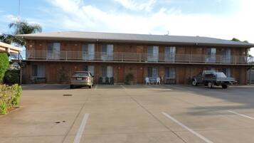 A two-story motel with a parking lot.