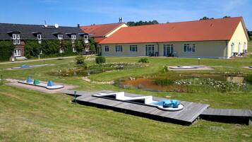 Residents can enjoy serene outdoor spaces with a pond, seating areas, and well-manicured lawn.