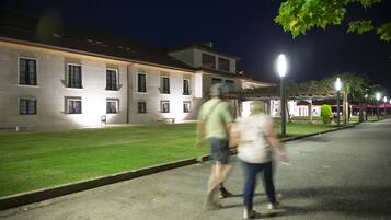 A building with multiple windows and a well-maintained lawn.