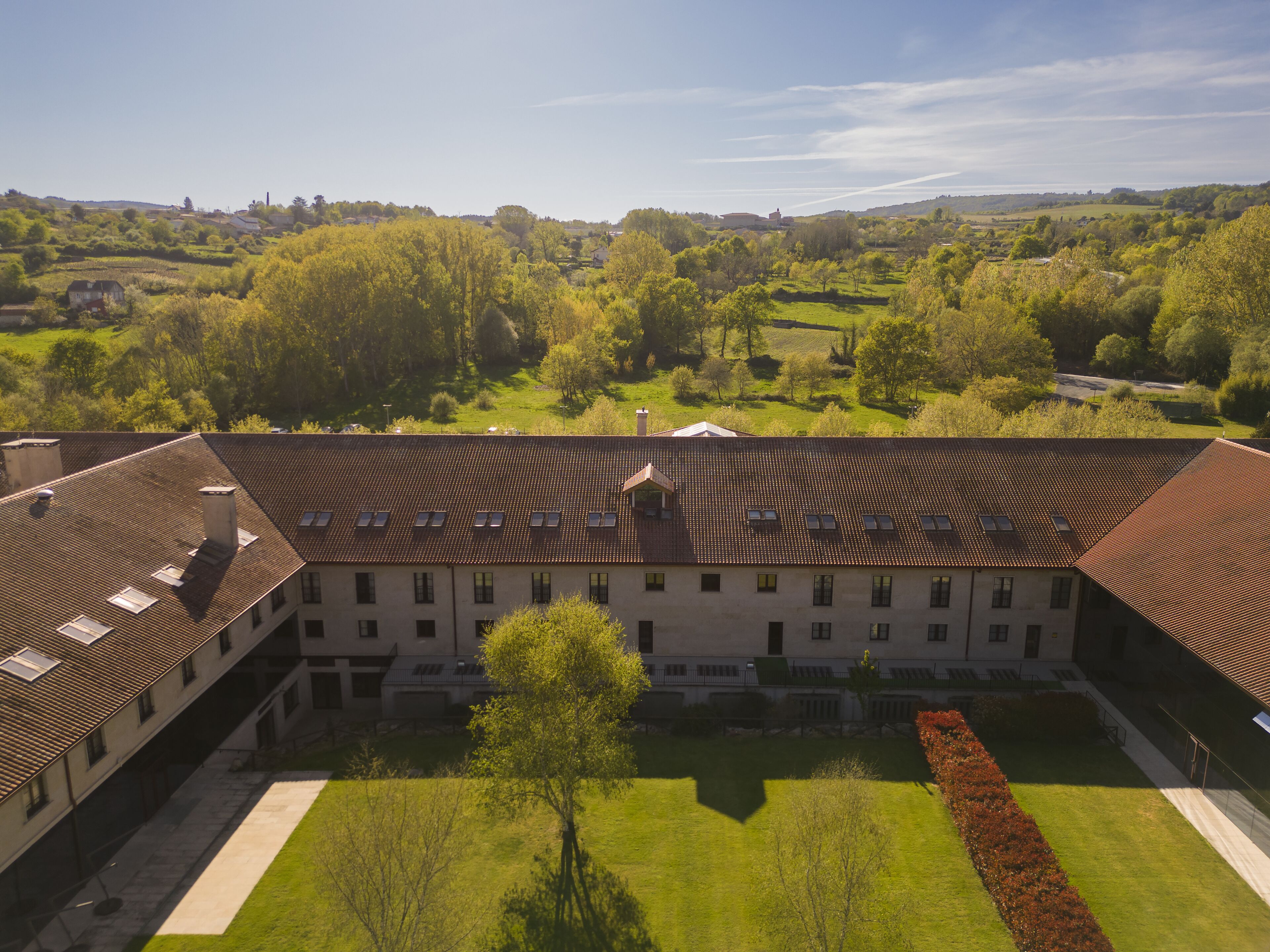 A large building with multiple windows and a courtyard.
