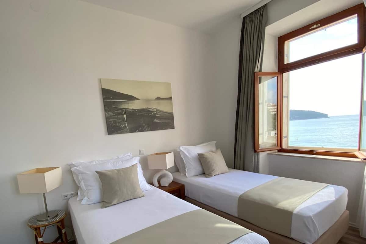 Family Room, 2 Bedrooms, Sea View | 1 bedroom, in-room safe, desk, iron/ironing board