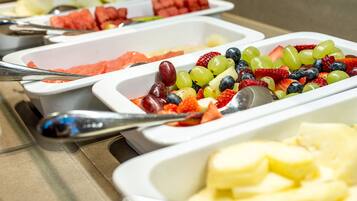 A buffet with various fruits and vegetables.