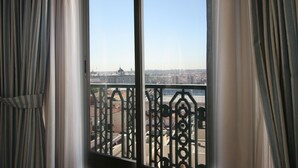 A view from a window with metal railings, overlooking a cityscape with buildings and a dome structure. - El Rincon de Gran Via (Madrid)