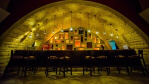 An arched ceiling with hanging lights and a seating area with chairs and tables. - Carols Beau Rivage Hotel (Marsa Matrouh)