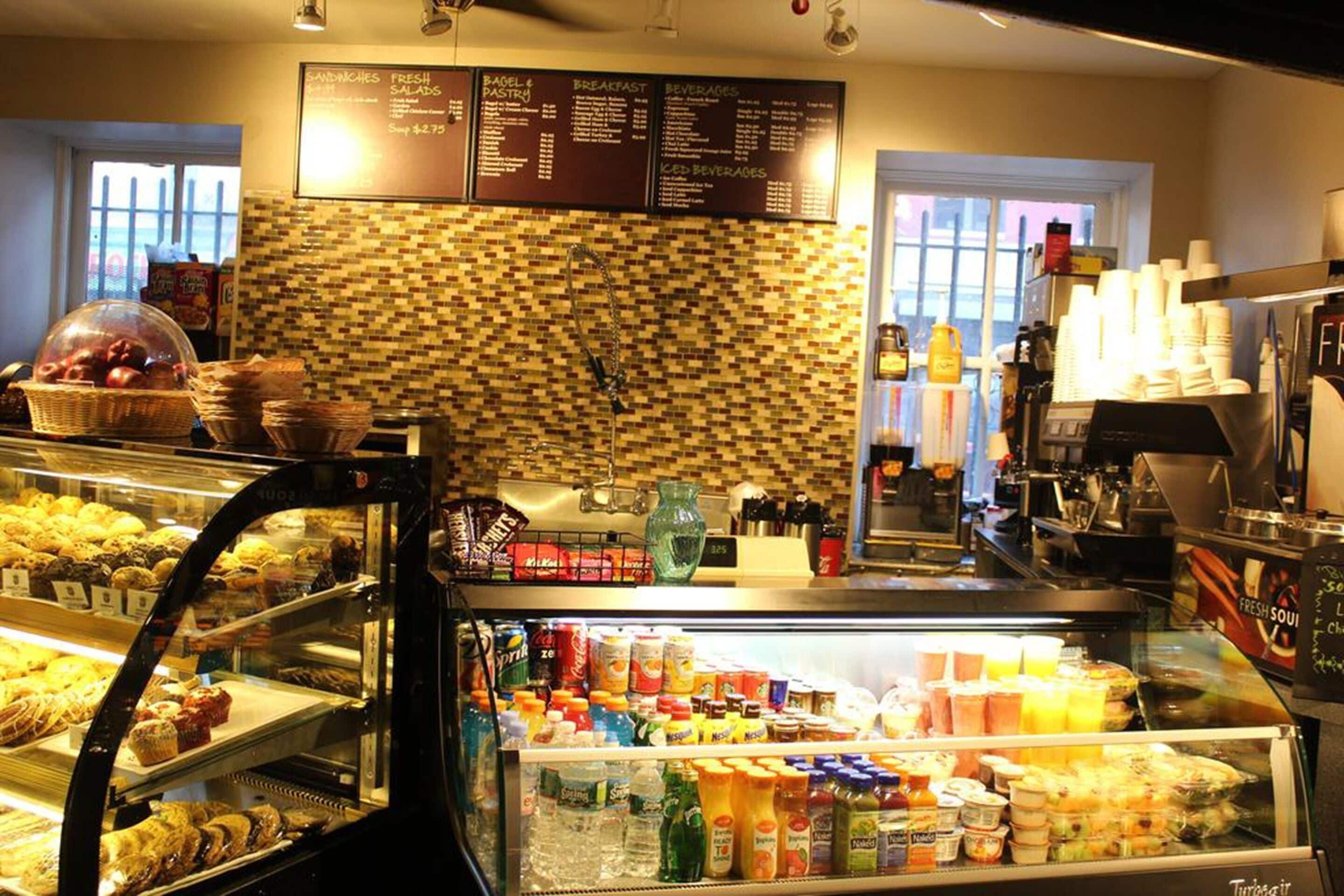 Mostrador de panadería con diversos productos horneados y una variedad de bebidas.