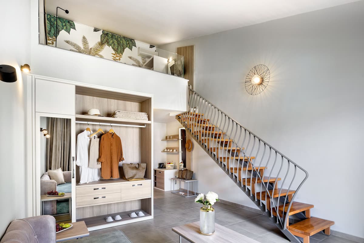 A modern interior with a staircase, a wardrobe, and a dining area.