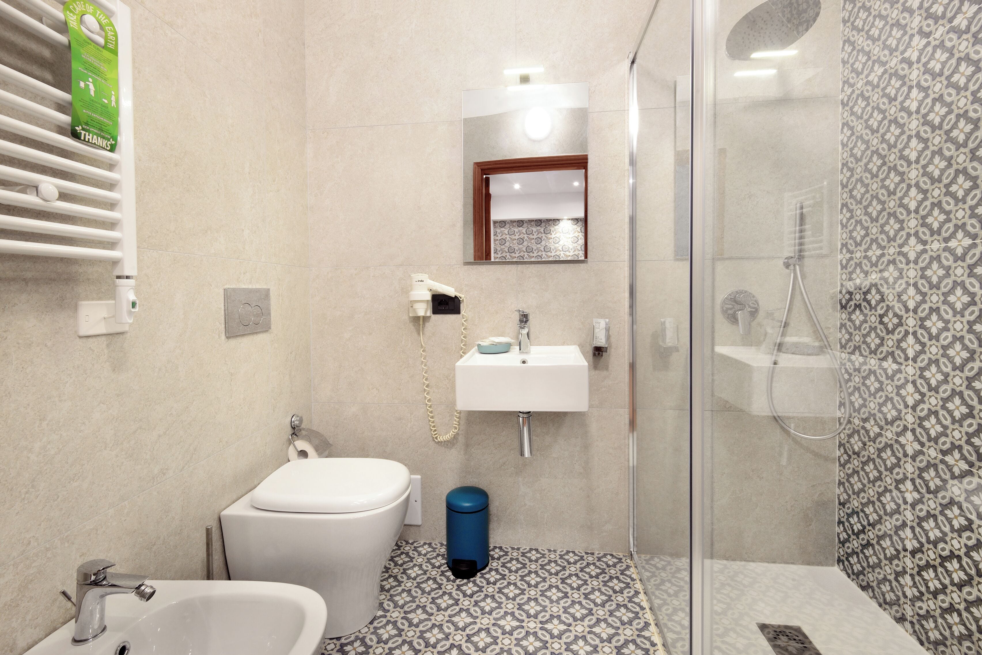 A bathroom with a toilet, sink, and shower.