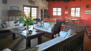 A cozy living room with a wooden ceiling, a pool table, and comfortable seating. - Arca Villa and B&B (Falmouth Harbour)
