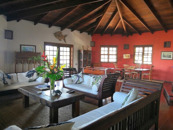 A cozy living room with a wooden ceiling, a pool table, and comfortable seating. - Arca Villa and B&B (Falmouth Harbour)