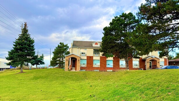 A two-story building with a brick facade, large windows, and a small entrance with a door. - Vaughan Inn (Vaughan)