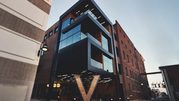 A modern building with a prominent V-shaped entrance and large glass windows.
