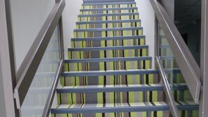 A staircase with striped carpet and metal railings. - Hôtel Arbor (Mulsanne)