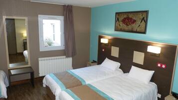 A hotel room with a large bed, a window with curtains, a mirror, and a painting on the wall.