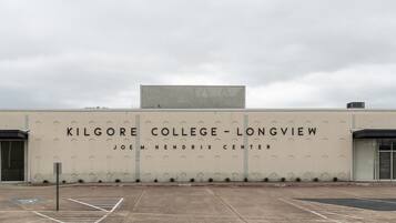 The exterior of Kilgore College - Longview, featuring a large sign with the college's name and the Joem Hendrix Center.