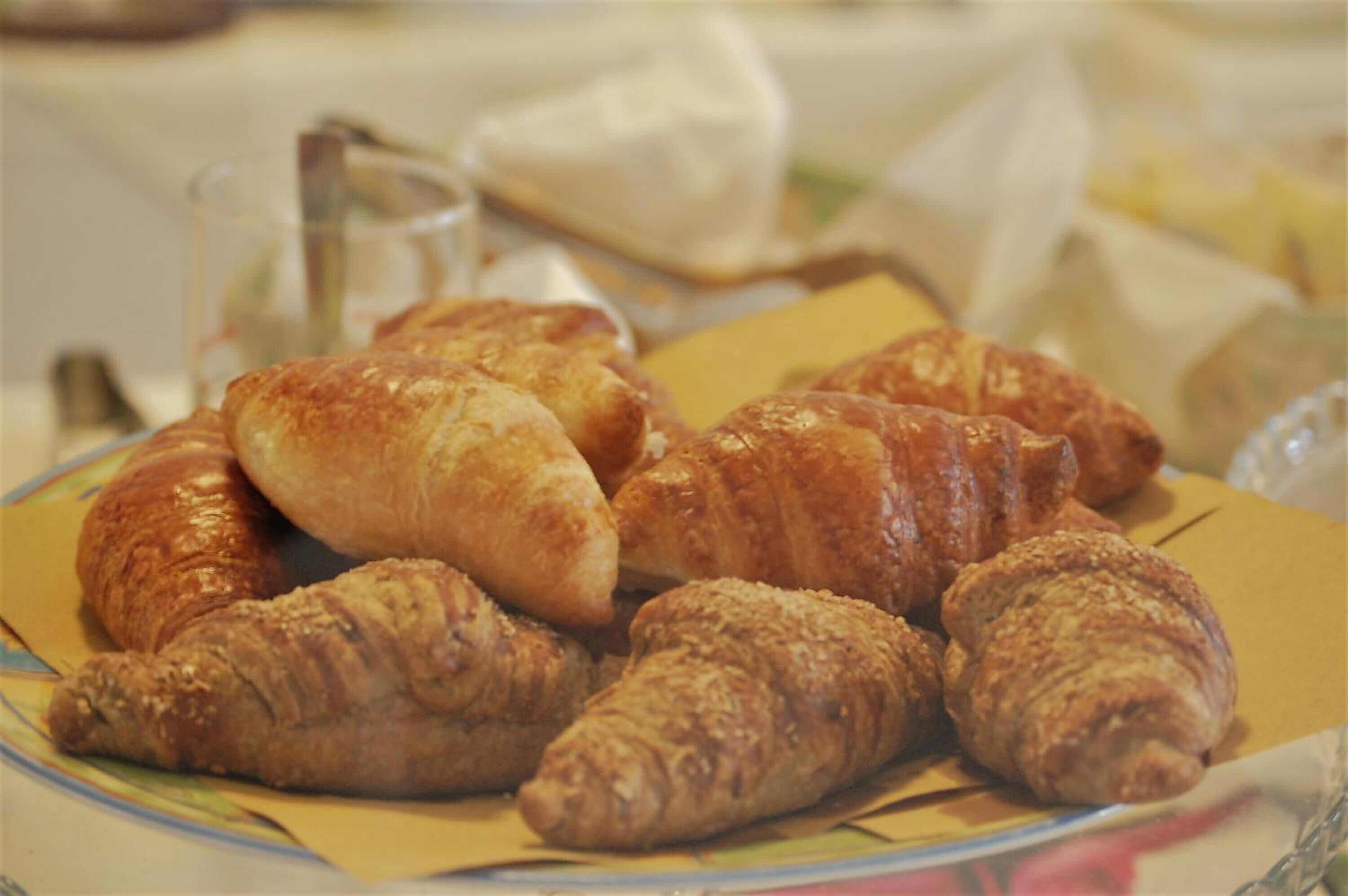 A plate of croissants on a table.