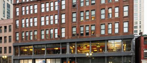 A multi-story building with large windows and a brick facade.