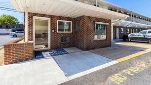 A two-story building with a brick facade, a covered entrance, and a parking area marked "No Parking." - Americas Best Value Inn Avenel Woodbridge (Avenel)