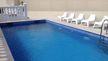 Outdoor pool, open 10:00 AM to 9:00 PM, pool umbrellas, pool loungers