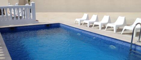 Outdoor pool, open 10:00 AM to 9:00 PM, pool umbrellas, pool loungers