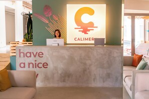 A reception desk with a 'have a nice day' sign, a Lenovo computer, and a Calimero logo. - Calimera Sunpark Alanya (Alanya)